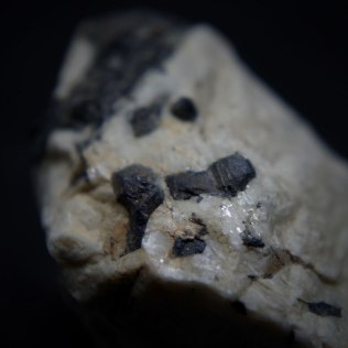 Strüverite (Ti,Ta,Fe)O2, U údražského obrázku quarry, Písek, South Bohemia Region, Bohemia, Czech Republic; crystals not bigger than 5mm