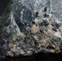 Blue sodalite (Na,K)AlSiO4, yellow cancrinite (Na,Ca,☐)8(Al6Si6O24)(CO3,SO4)2·2H2O and black pyroxene – aegirine NaFeSi2O6 in nepheline (Na,K)AlSiO4 pegmatie; Donskoy quarry, Mazurovskoe Zr deposit, Oktyabr'skii Massif (Mariupol'skii), Azov Sea Region, Donetsk (Donets'k) Oblast', Ukraine; FOV: 36 mm