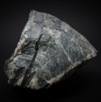 Pyroxene – aegirine NaFe3+Si2O6 crystals in nepheline (Na,K)AlSiO4; Donskoy quarry, Mazurovskoe Zr deposit, Oktyabr'skii Massif (Mariupol'skii), Azov Sea Region, Donetsk (Donets'k) Oblast', Ukraine; longest aegirine crystal: 40 mm