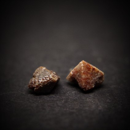 Two fragments of crystals of zircons Zr(SiO4); Marabá, Carajás mineral province, Pará, Brazil; bigger crystal about 9 mm
