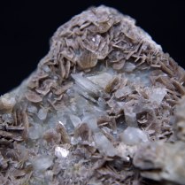 Cluster of small crystals of axinite (probably axinite-(Fe) Ca2FeAl2BSi4O15OH) with quartz SiO2; Zbraslav, Prague District (Praha District), Bohemia (Böhmen; Boehmen), Czech Republic; FOV: 35 mm