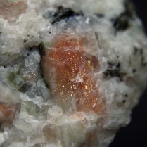 Sunstone - reddish plagioclase (oligoclase) (Na,Ca)[Al(Si,Al)Si2O8] with inclusions of hematite Fe2O3; Bjordam Sunstone Quarry, Bjordam, Bamble (Bamle), Telemark, Norway; crystal 8 x 11 mm