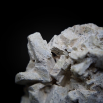 White platy gehlenite Ca2Al(AlSiO7) crystals; Vaţa de Sus, Hunedoara Co., Romania; FOV: 35 mm