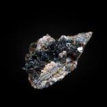 Lustrous crystals of dark blue lazulite (Mg,Fe)Al2(PO4)2(OH)2 on matrix; Rapid Creek, Dawson Mining District, Yukon, Canada; 35 x 20 x 9 mm