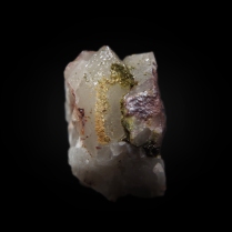 Green, minute pumpellyite-(Fe2+) Ca2Fe"Al2(Si2O7)(SiO4)(OH)2·H2O crystals on the surface of white quartz SiO2 with minor reddish hematite Fe2O3; Baveno, Verbano-Cusio-Ossola Province, Piedmont, Italy; 22 x 15 x 14 mm