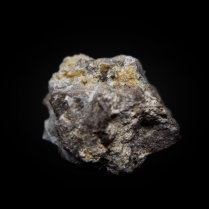 Clusters of pale yellow acicular pumpellyite-(Mn2+) Ca2Mn"Al2(Si2O7)(SiO4)(OH)2·H2O crystals on matrix; Valgraveglia Mine, (Gambatesa Mine), Monte Copello, Reppia, Ne, Graveglia Valley, Genova Province, Liguria, Italy; 31 x 26 x 22 mm