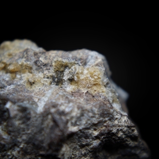 Pale yellow acicular pumpellyite-(Mn2+) Ca2Mn"Al2(Si2O7)(SiO4)(OH)2·H2O crystals on matrix; Valgraveglia Mine, (Gambatesa Mine), Monte Copello, Reppia, Ne, Graveglia Valley, Genova Province, Liguria, Italy; FOV: 20 mm
